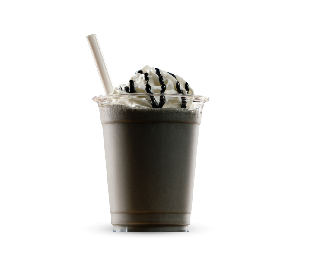 Tumma pirtelö kermavaahdolla kupissa.